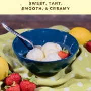 Lemon Sherbet scooped in blue bowl on green towel with strawberries & lemons Pinterest banner.