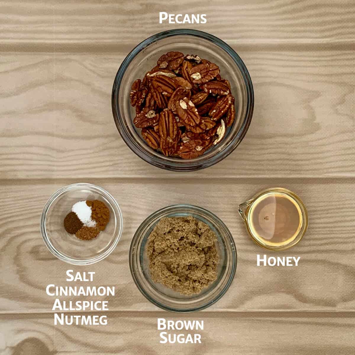 Ingredients for candied pecans portioned into glass bowls.