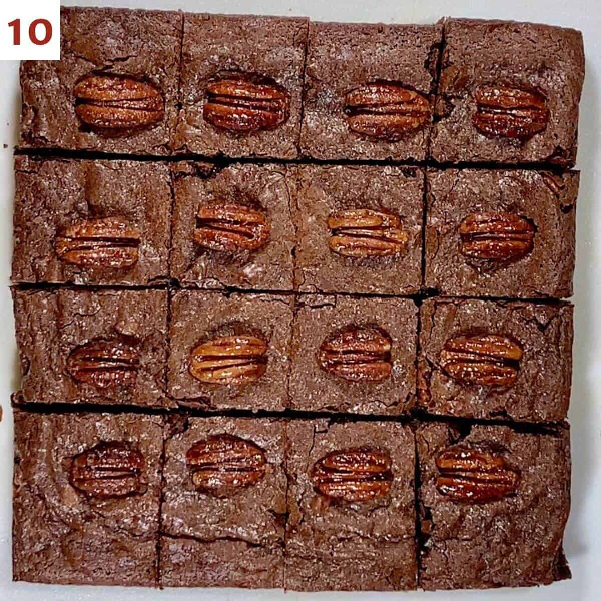 Whiskey brownies topped with candied pecans cut into squares.