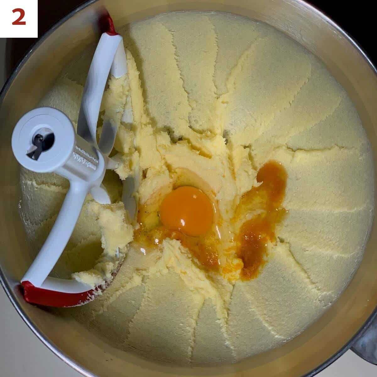 Adding egg, vanilla, & orange zest to creamed butter & sugar to the butter mixture.