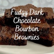 Stack of bourbon brownies on a white cake stand Pinterest banner.