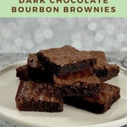 Stack of bourbon brownies on a white cake stand Pinterest banner.