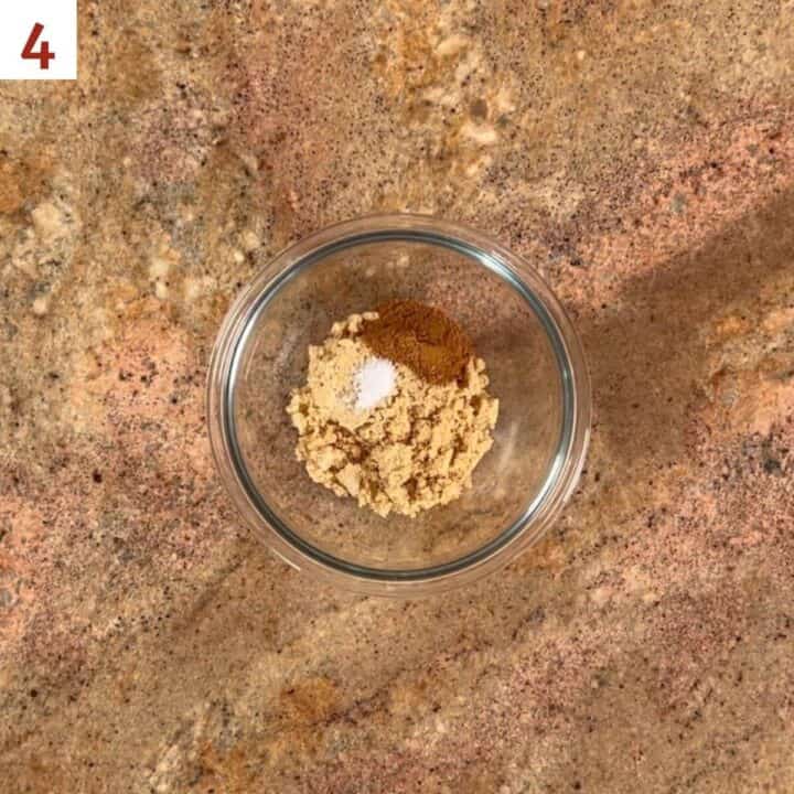 Brown sugar, cinnamon, and salt in a glass bowl.