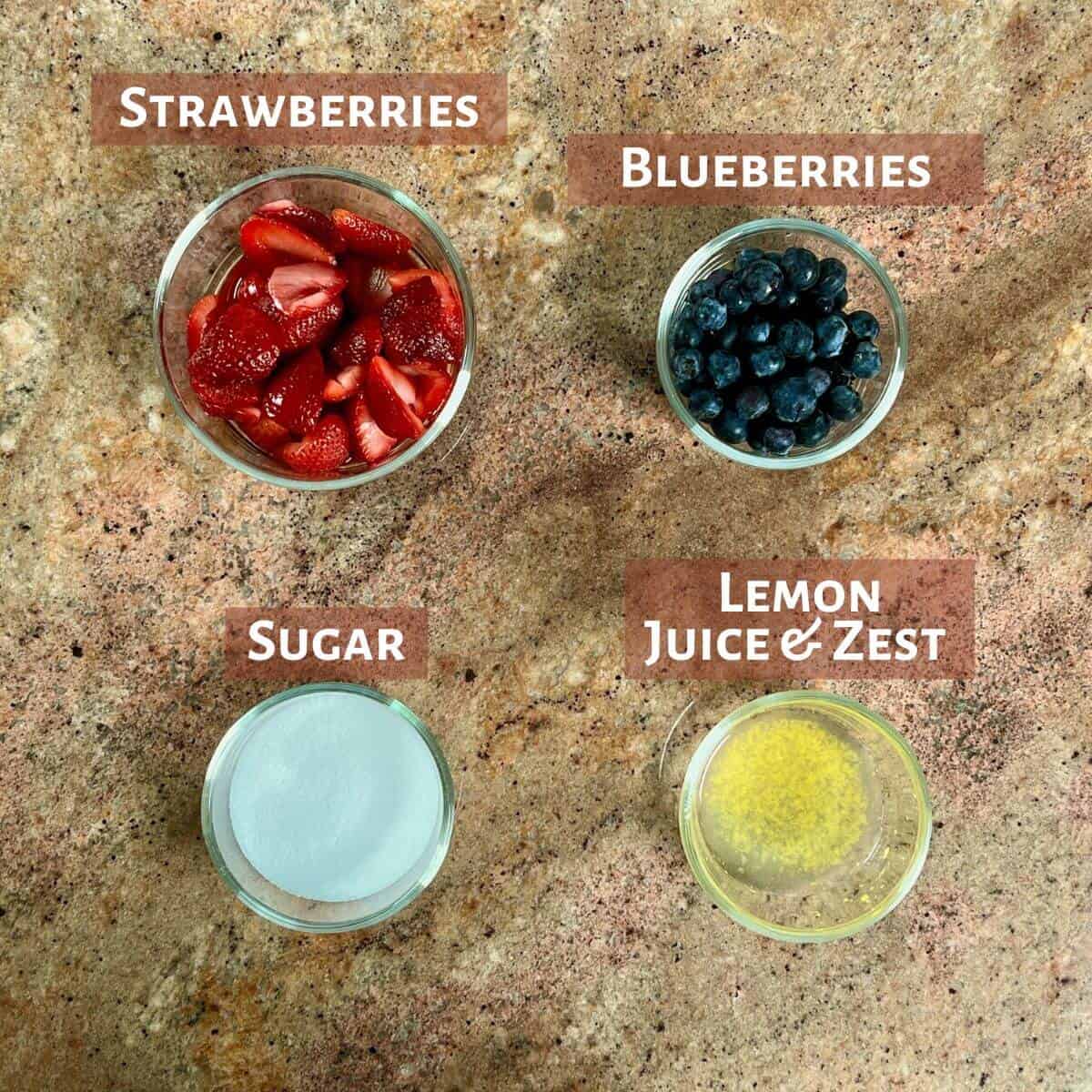Ingredients for mixed berry jam portioned into glass bowls.