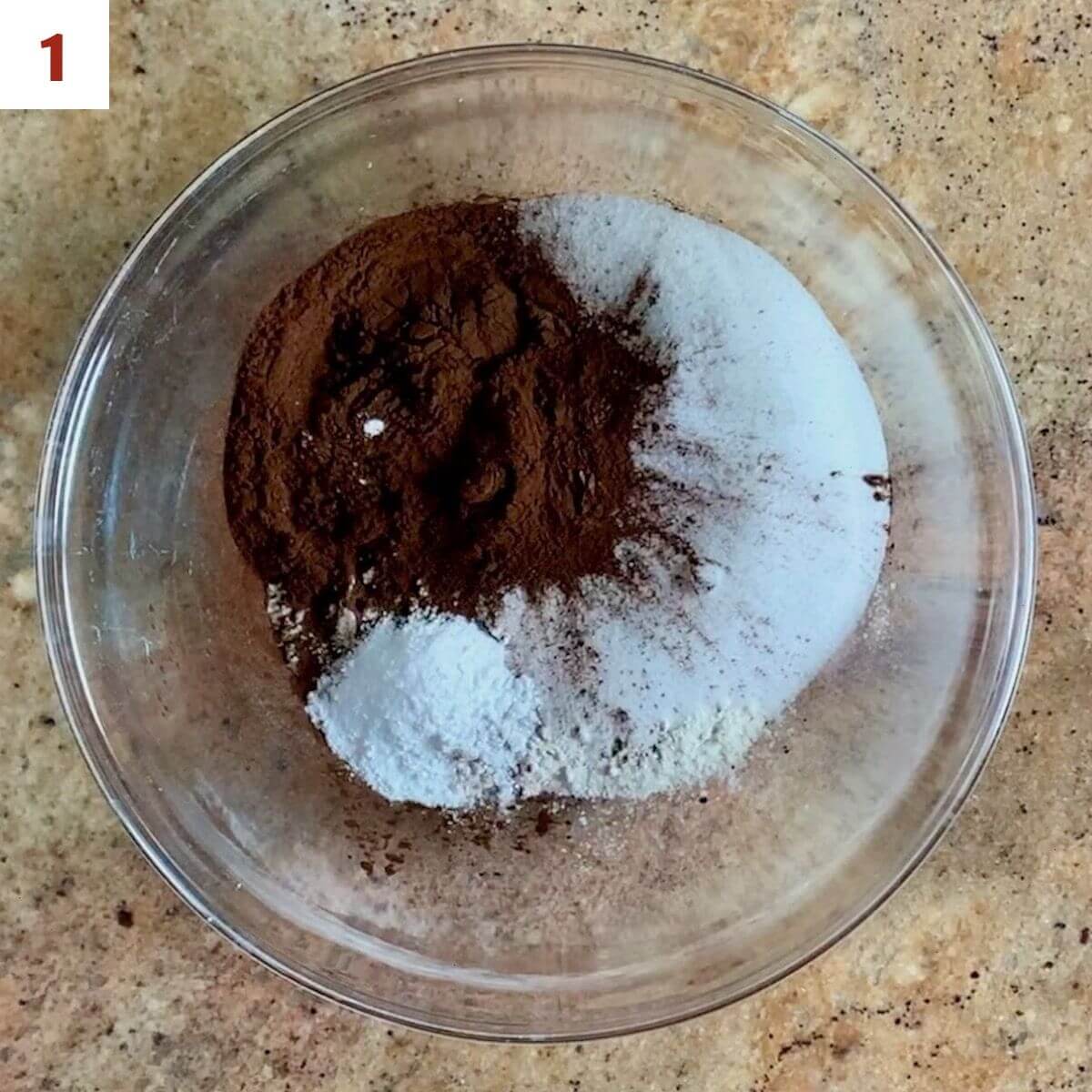 Flour, sugar, cocoa powder, baking soda, and salt in a glass bowl.