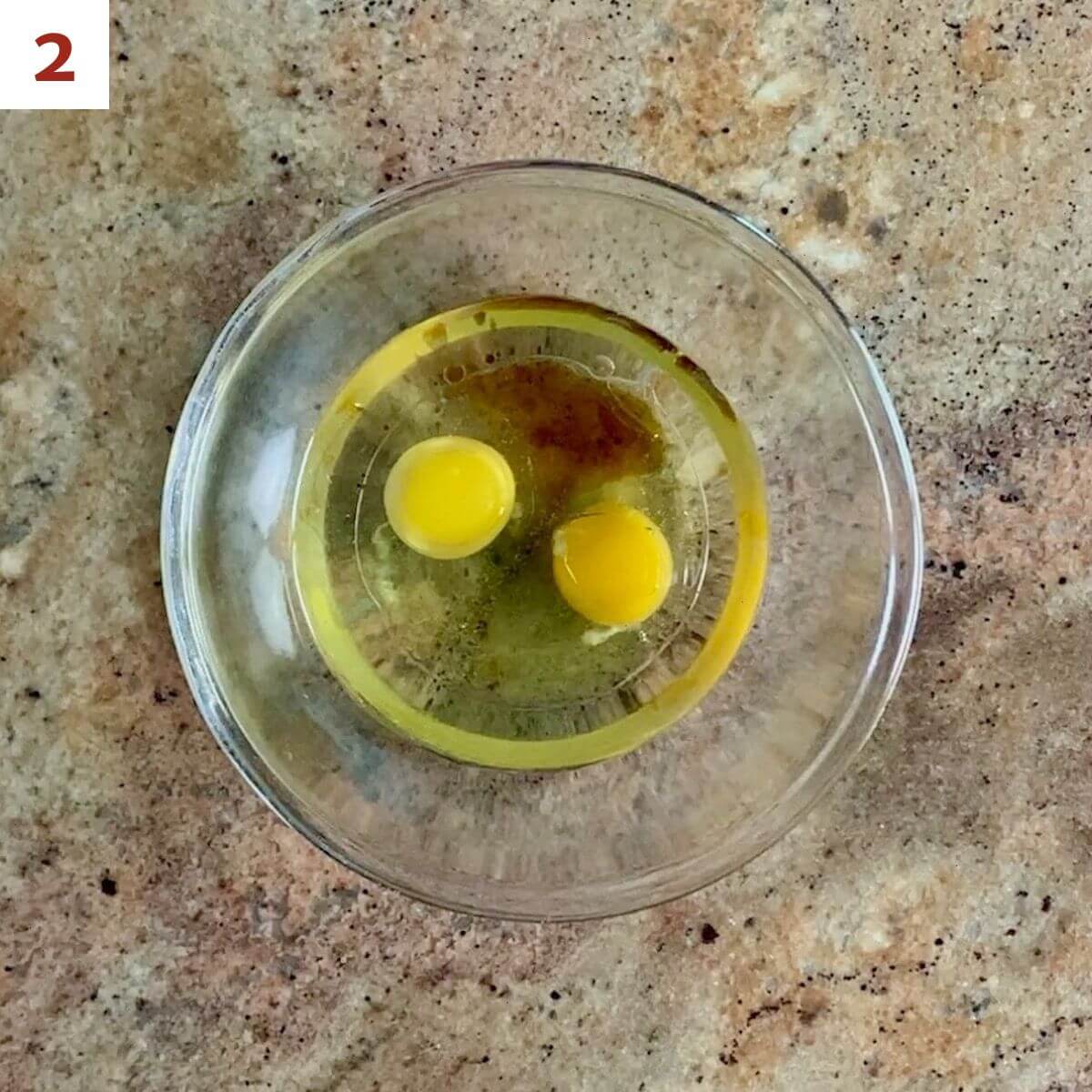 Canola oil, eggs, & vanilla in a glass bowl.