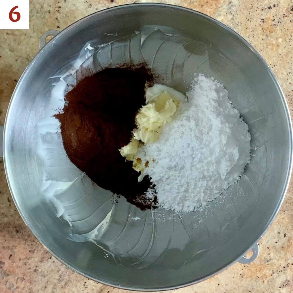 Butter, powdered sugar, cocoa powder, milk, and vanilla in a mixer bowl.