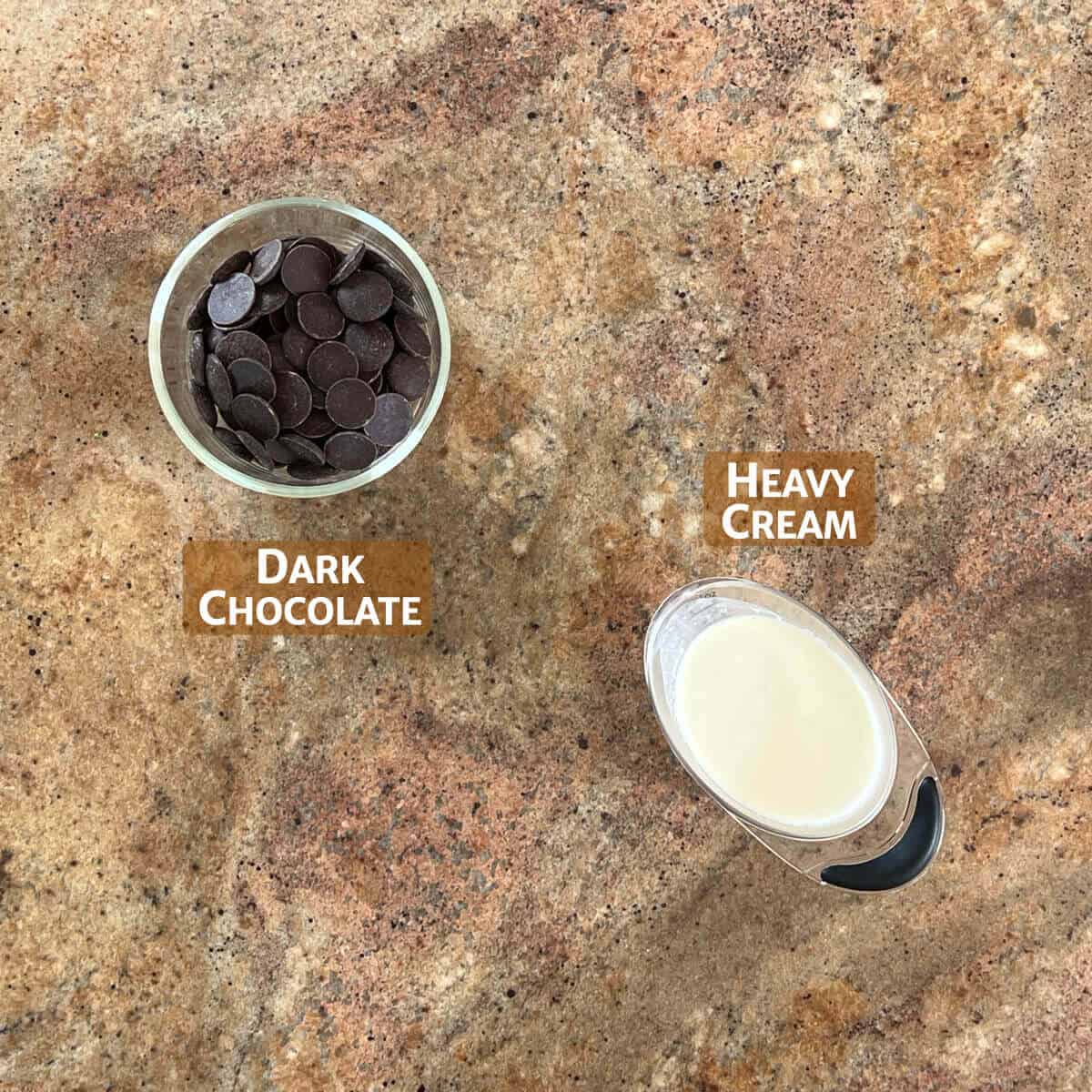 heavy cream and chopped chocolate in glass bowls from overhead.