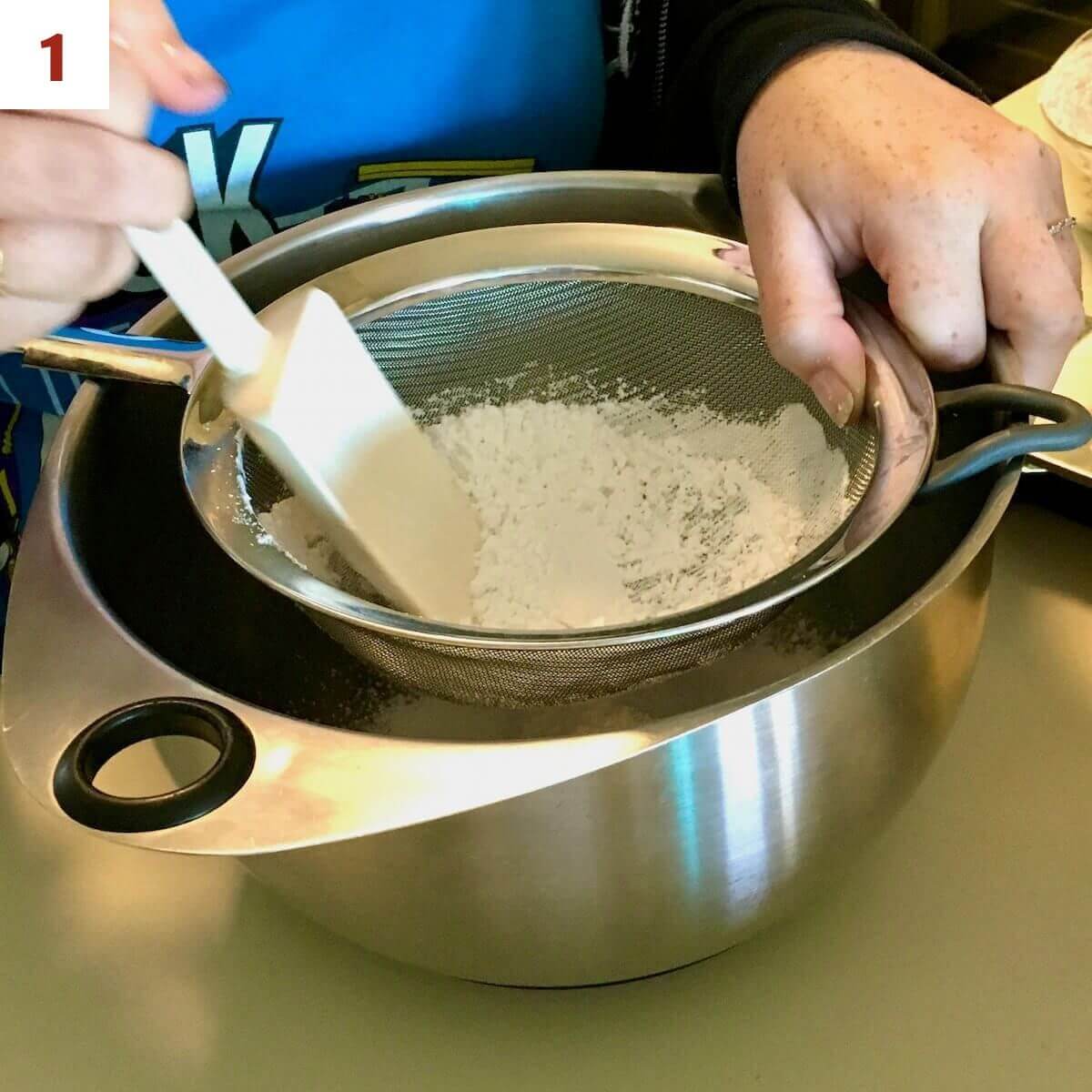 Sifting almond flour and powdered sugar for French macarons.