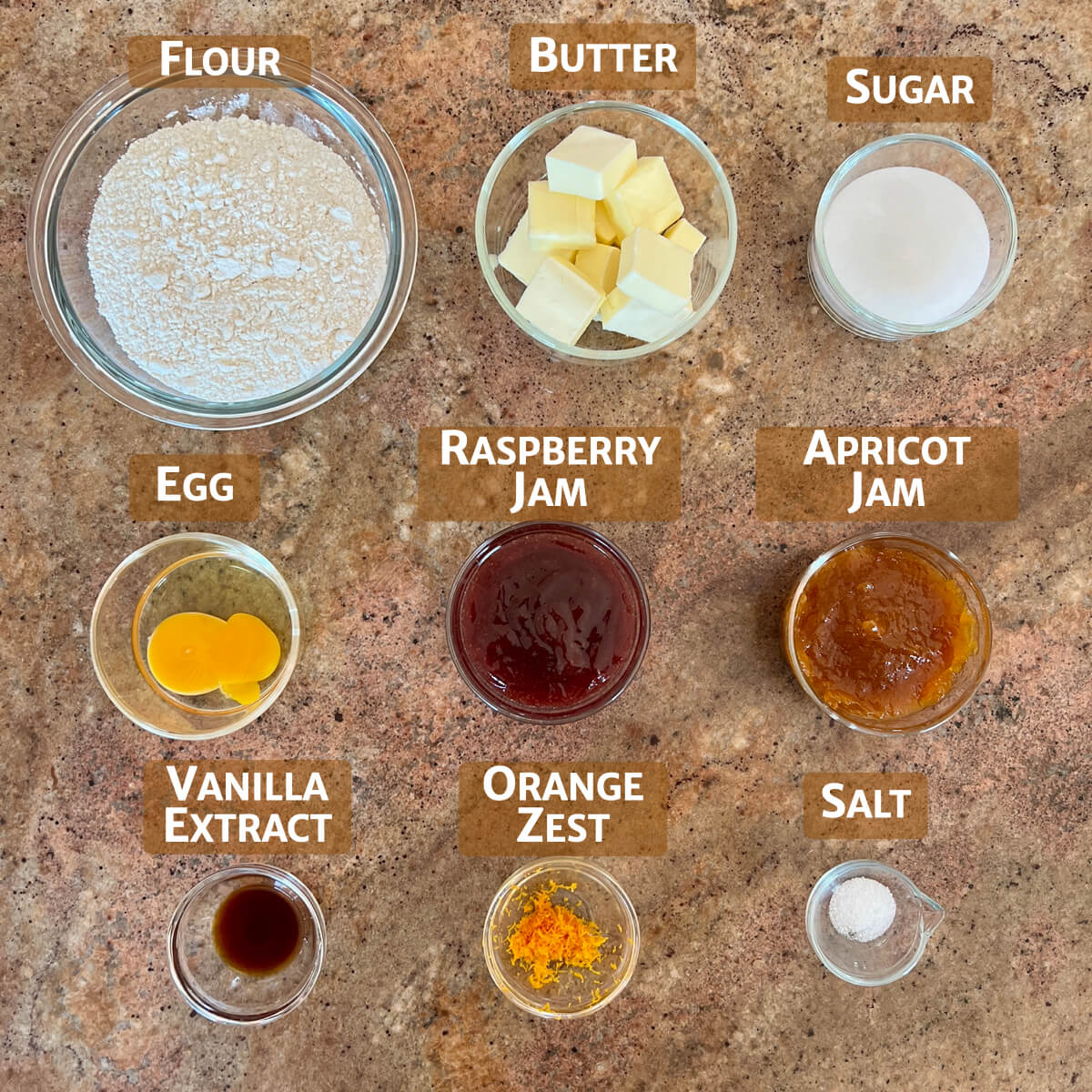 Ingredients for Hamantaschen cookies portioned into glass bowls.