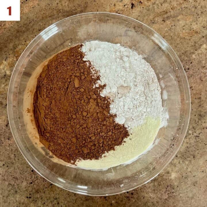 Ingredients for hot cocoa mix in a large glass bowl.