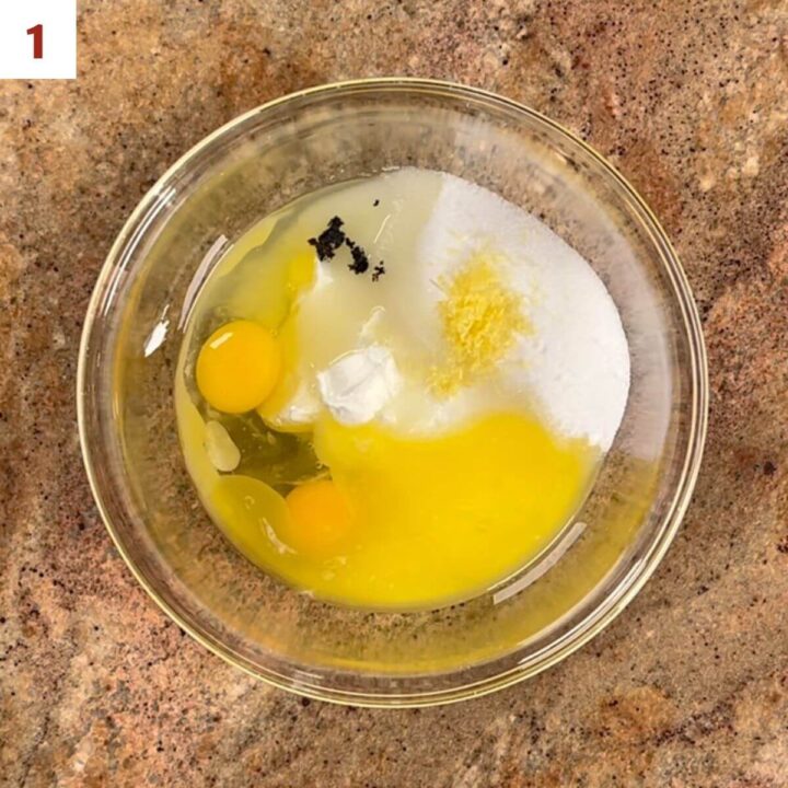 Yogurt, eggs, melted butter, sugar, limoncello, & vanilla beans in a glass bowl.