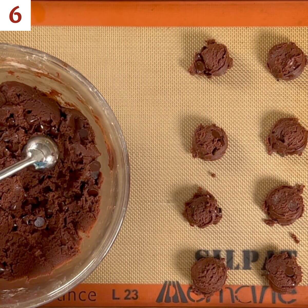 Portioning finished dough into balls on a baking pan.