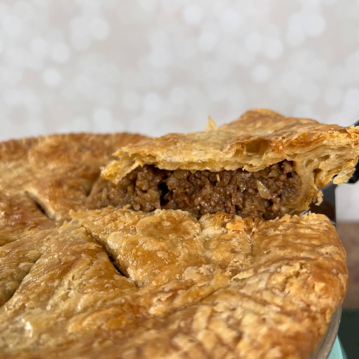 Moroccan Beef Pie with slice lifted from the pan.