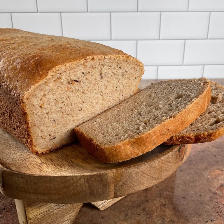 Sourdough Rye Sandwich Bread sliced on a bread board.