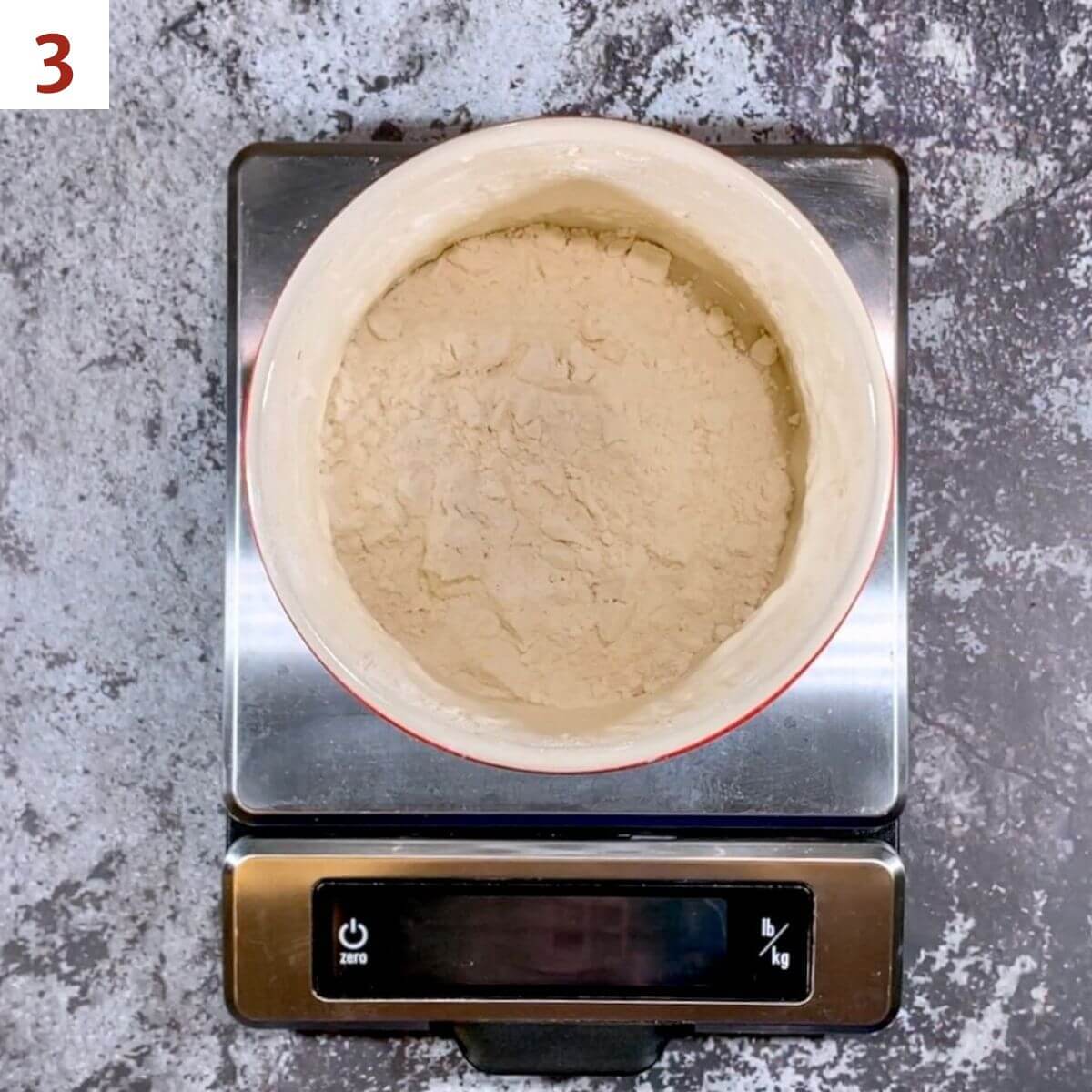 Adding flour to sourdough starter on a scale.