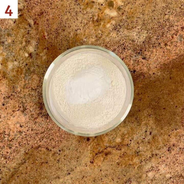 Mixing the flour, baking powder, and salt in a glass bowl.