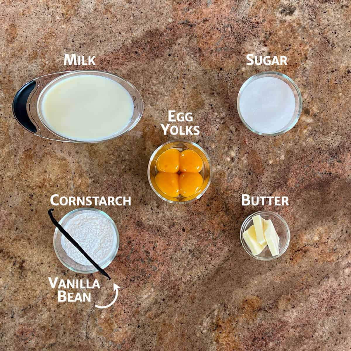 Ingredients for pastry cream portioned into glass bowls.