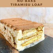 Sliced end of a loaf of Tiramisu on a black platter pinterest banner.