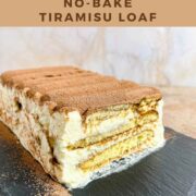 Sliced end of a loaf of Tiramisu on a black platter pinterest banner.