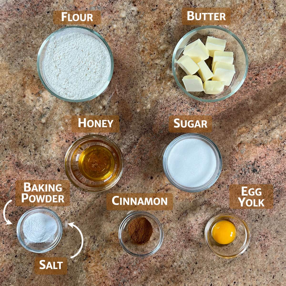 Ingredients for honey cookies portioned into glass bowls.