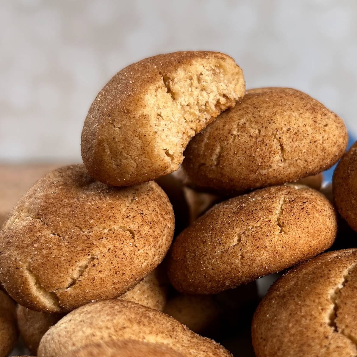 Stack of honey cookies with a bite taken out of the top one.