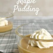 Two servings of maple pudding each with a dollop of whipped cream next to a spoon on a green checked cloth Pinterest banner.