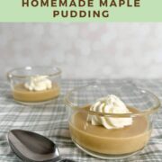 Two servings of maple pudding each with a dollop of whipped cream next to a spoon on a green checked cloth Pinterest banner.