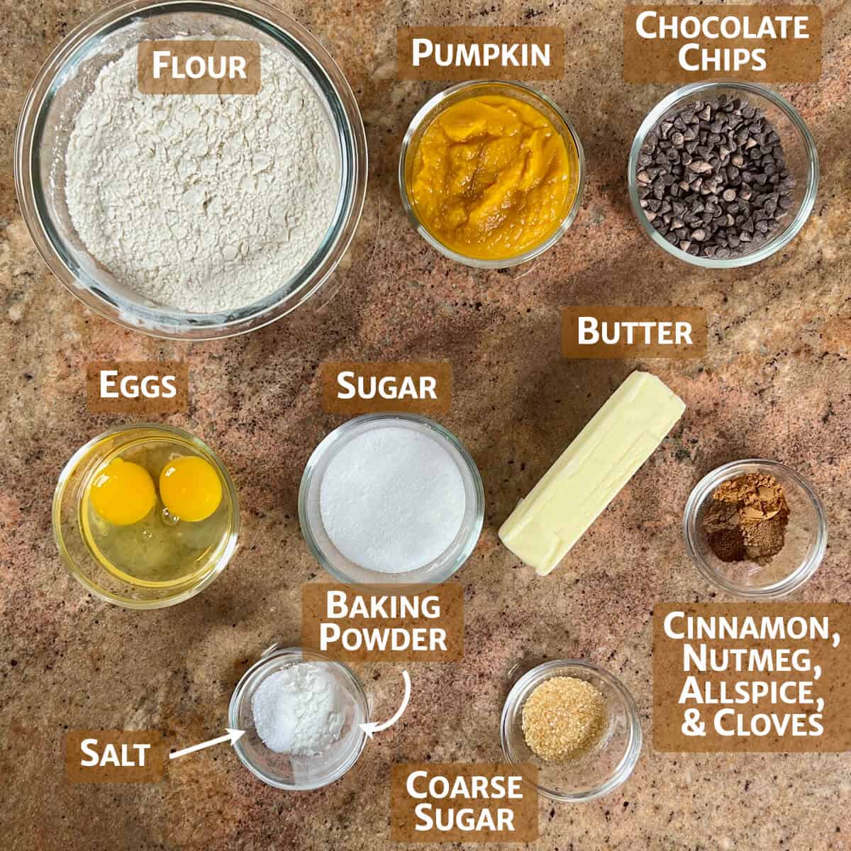 Ingredients for pumpkin chocolate chip scones portioned into glass bowls.