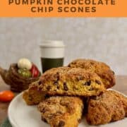 Pumpkin Chocolate Chip Scones stacked on a white cake stand in front of a coffee cup and basket of small pumpkins Pinterest banner.