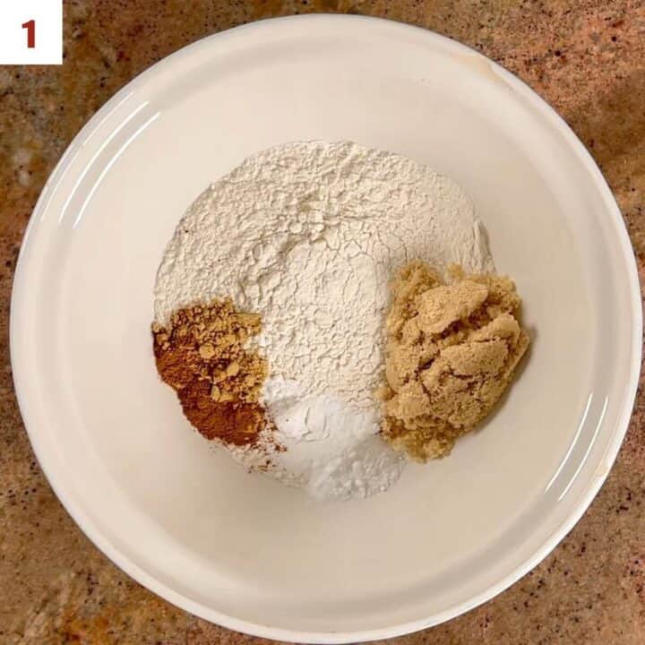 Flour, brown sugar, baking powder, baking soda, and spices in a bowl.