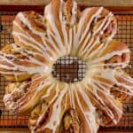 The finished drizzled tea ring on a cooling rack.