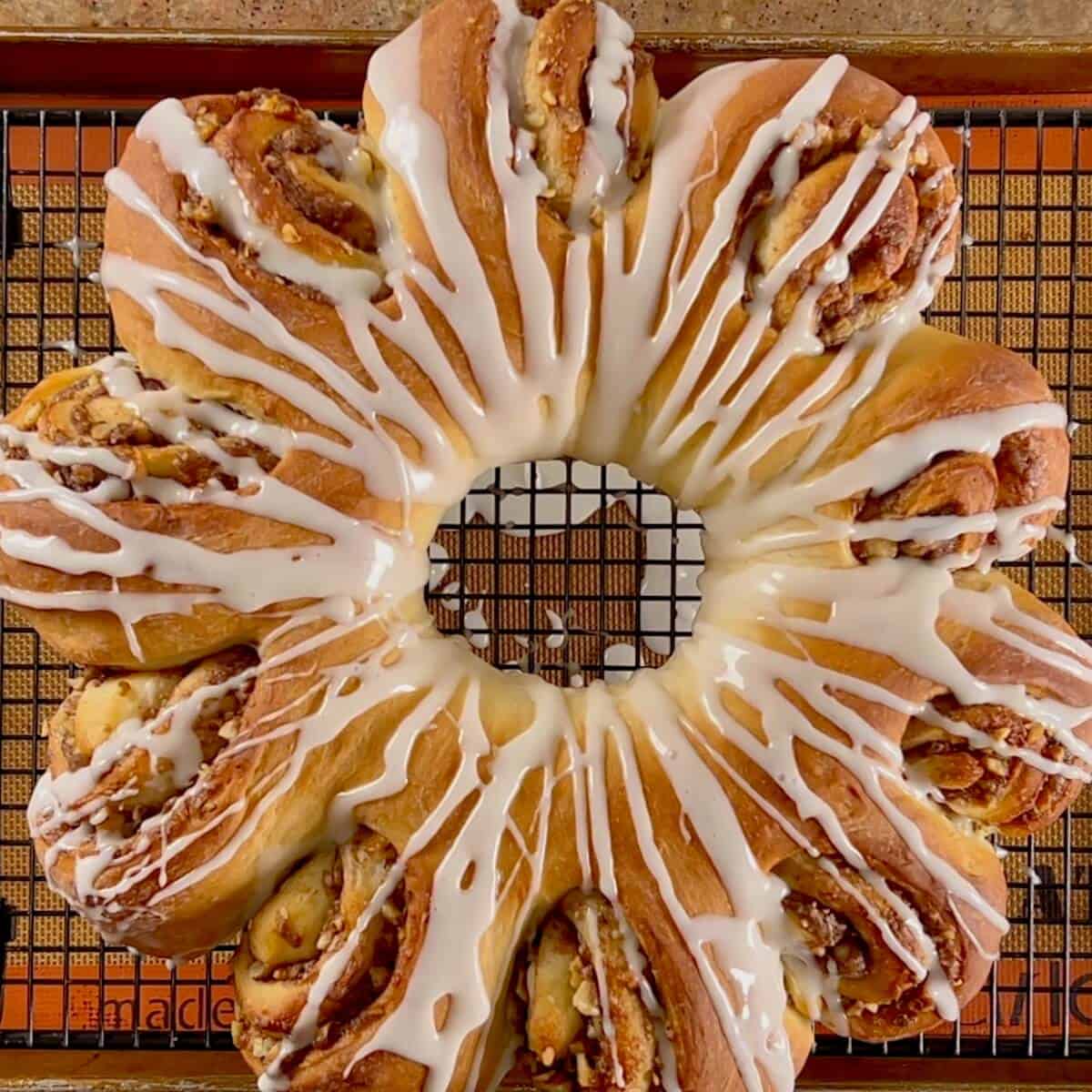 The finished drizzled tea ring on a cooling rack.