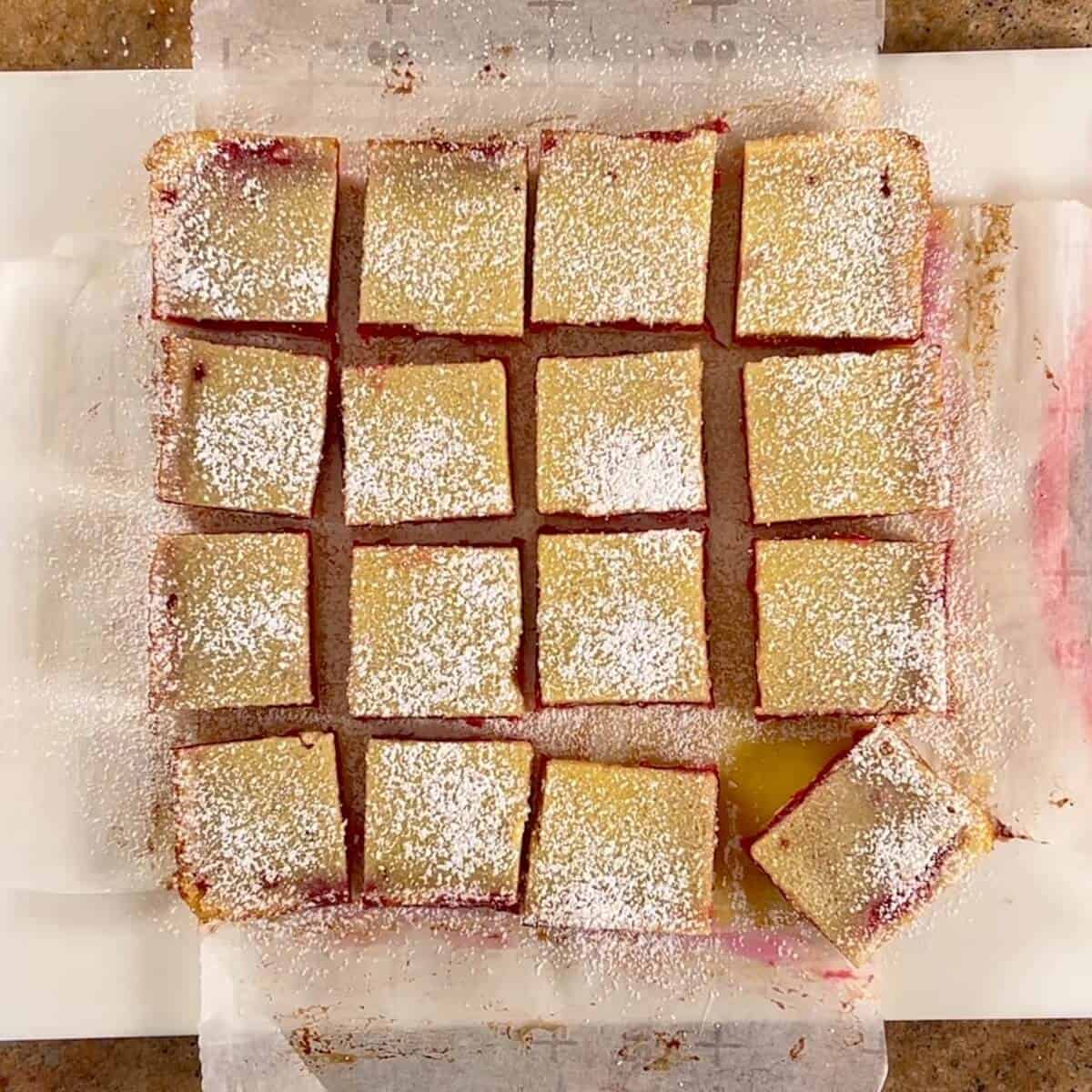 Cut Cranberry Lemon Bars on a cutting board.