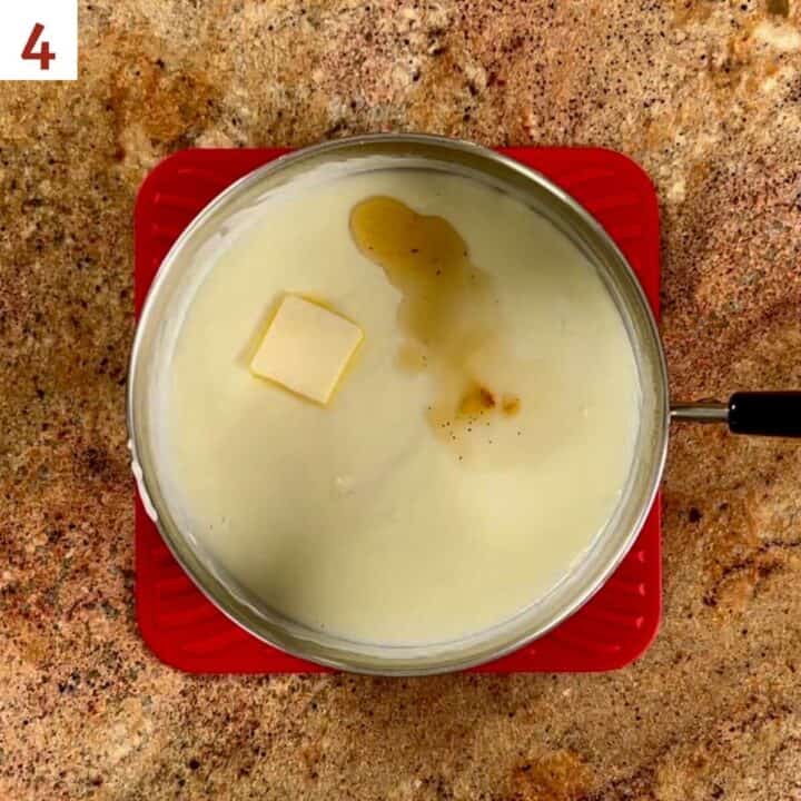 Adding butter and vanilla to the cooked pudding.