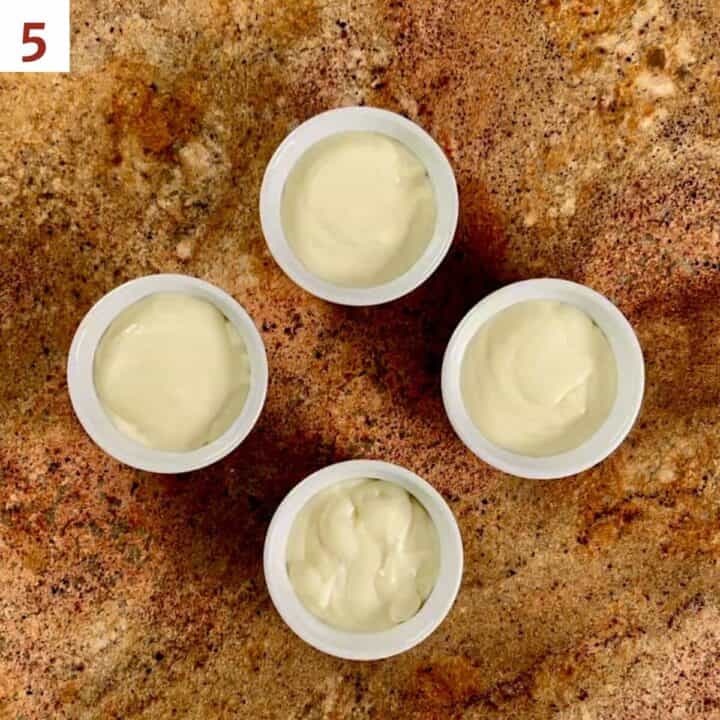 Vanilla pudding portioned into 4 ramekins.