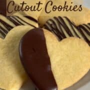 Heart shaped shortbread cutout cookies stacked on a white plate Pinterest banner.