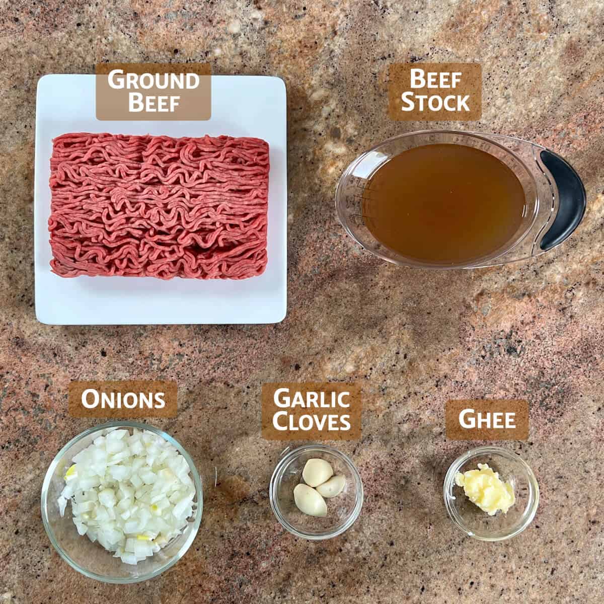 Main ingredients for Cincinnati chili portioned into glass bowls or on a white plate.