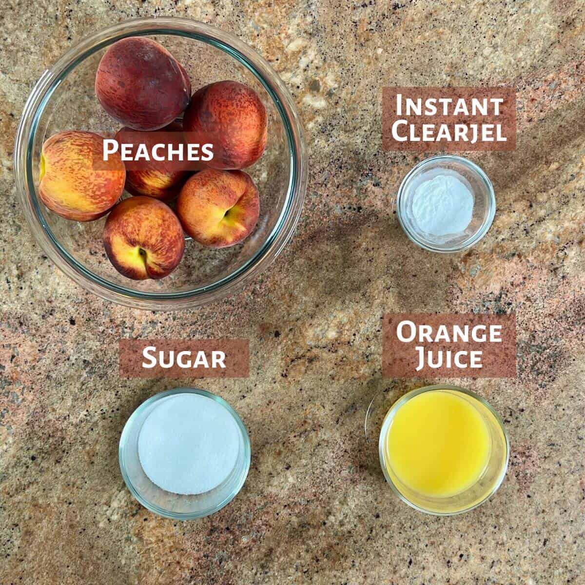 Ingredients for the peach cobbler filling portioned into glass bowls.