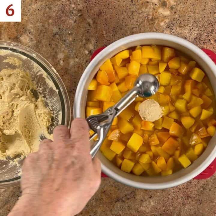 Scooping the cookie topping onto the peach filling.