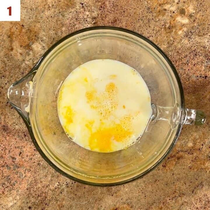 eggs, milk, sourdough starter discard, and salt in a glass bowl.