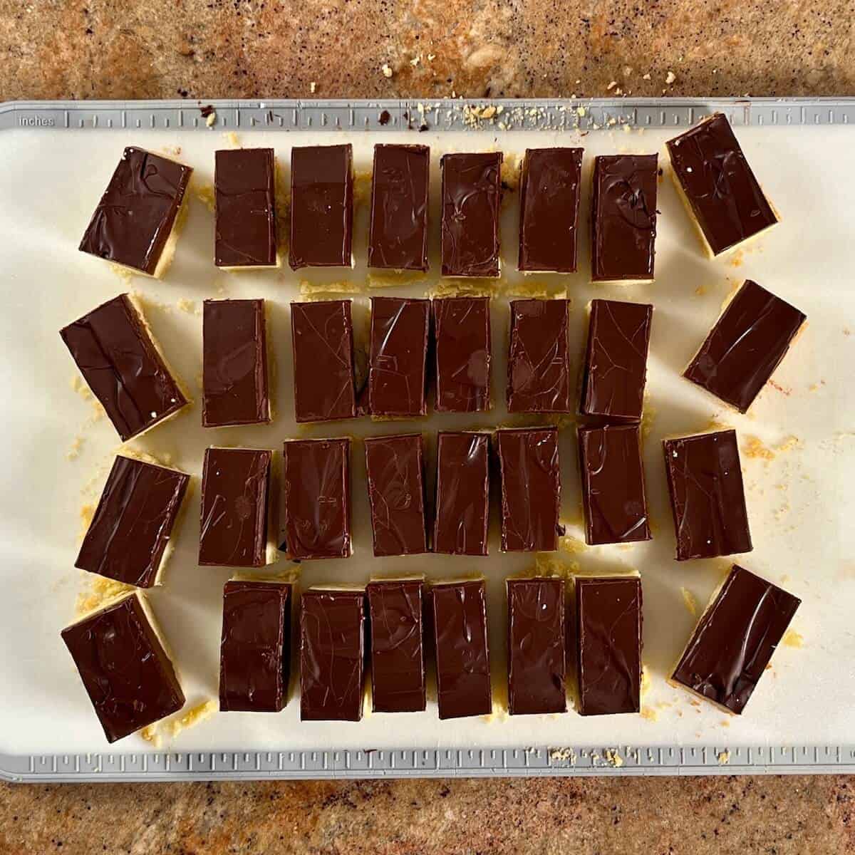 Portioned Millionaire's Shortbread on a cutting board.