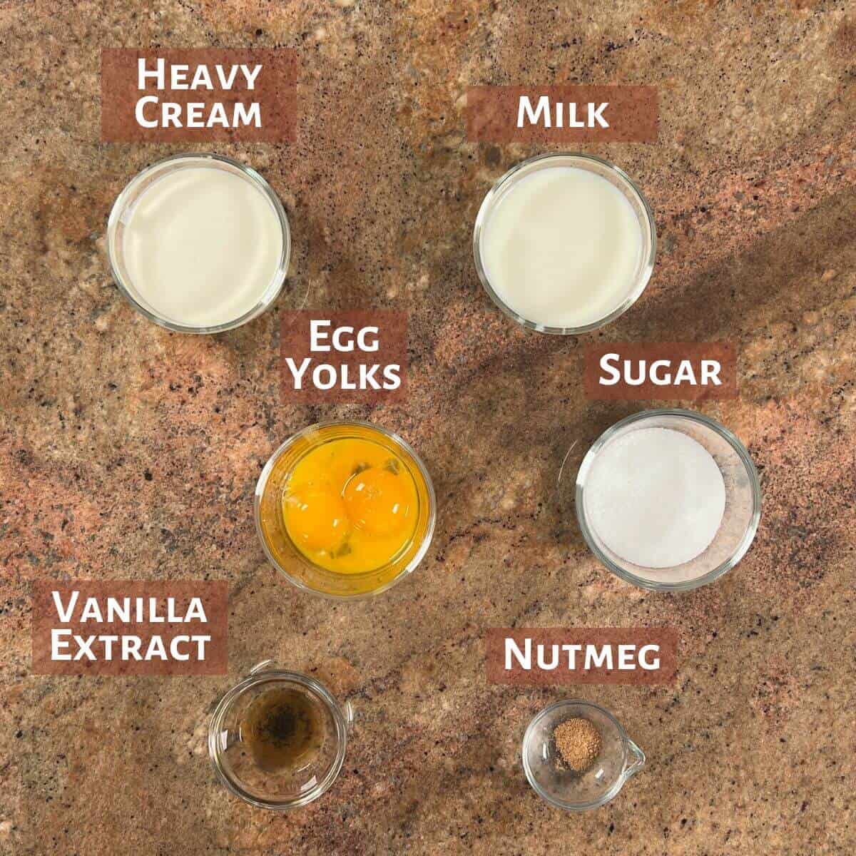 Ingredients for egg custard portioned into glass bowls.