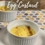 Three ramekins of egg custard set on a patterned cloth Pinterest banner.