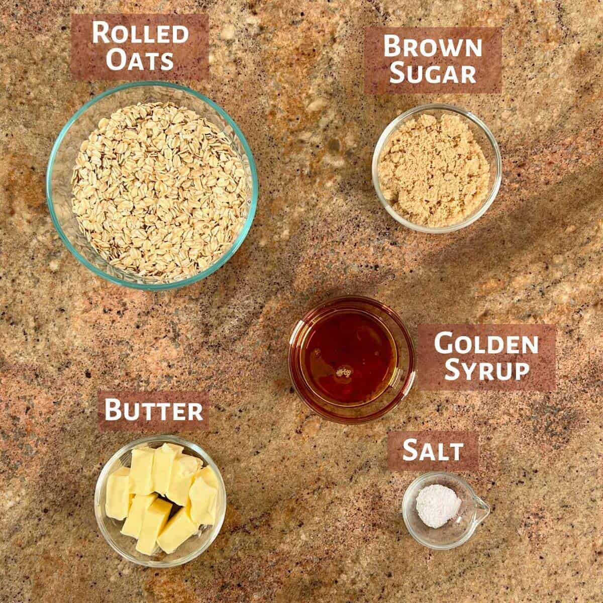Ingredients for British flapjacks portioned into glass bowls.