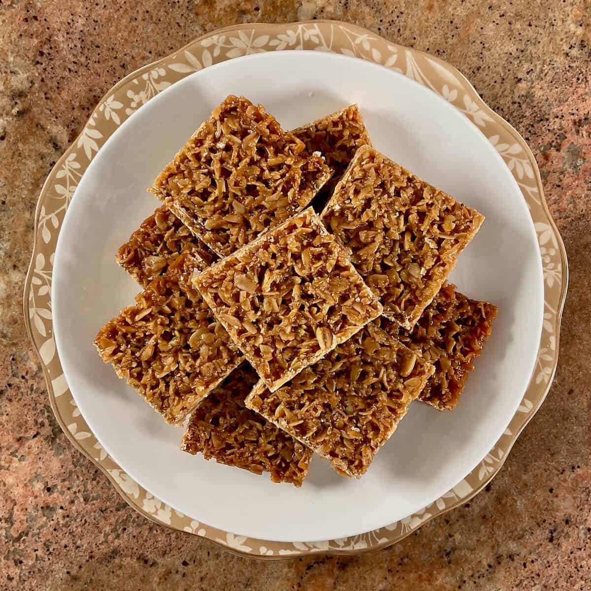 British flapjacks stacked on a white plate from overhead.