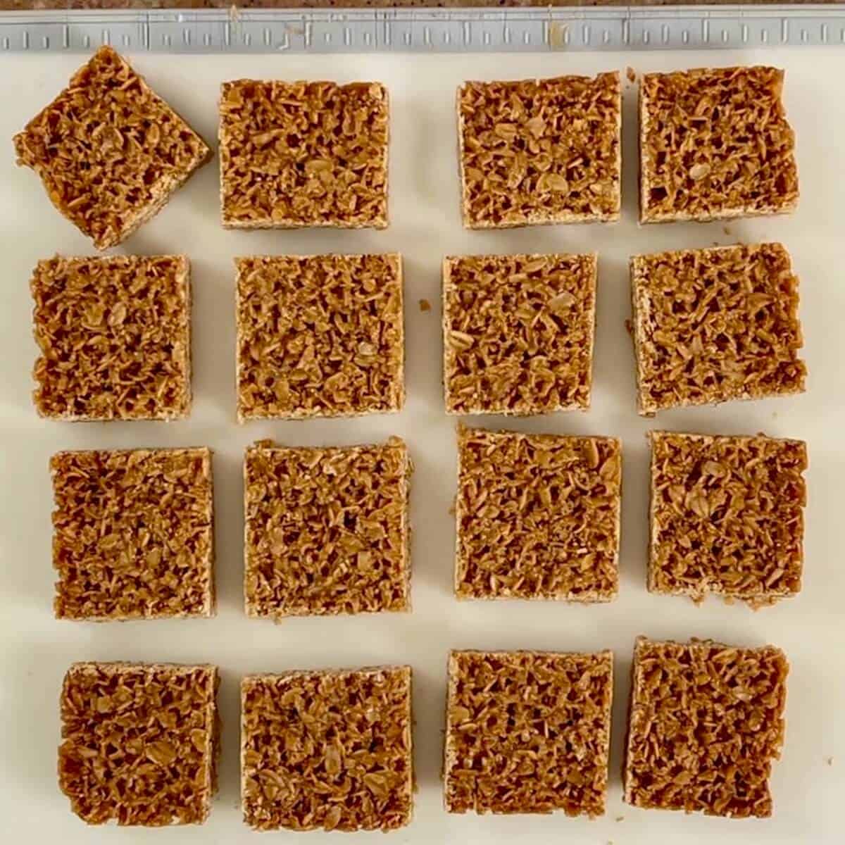 British flapjacks cut into squares and spread out on a cutting board.