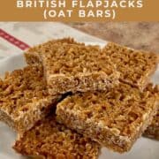 British flapjacks stacked on a white plate Pinterest banner.