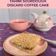 Sourdough Discard Tahini Coffee Cake and a fork on a pink plate with a pink teacup and teapot behind it Pinterest banner.