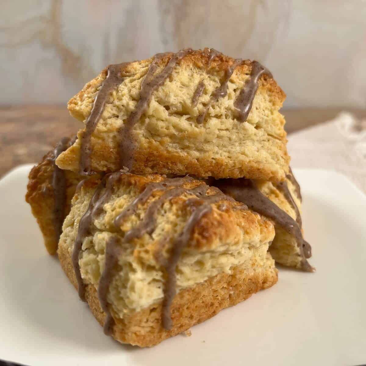Vanilla Bean Scones stacked on a white plate.